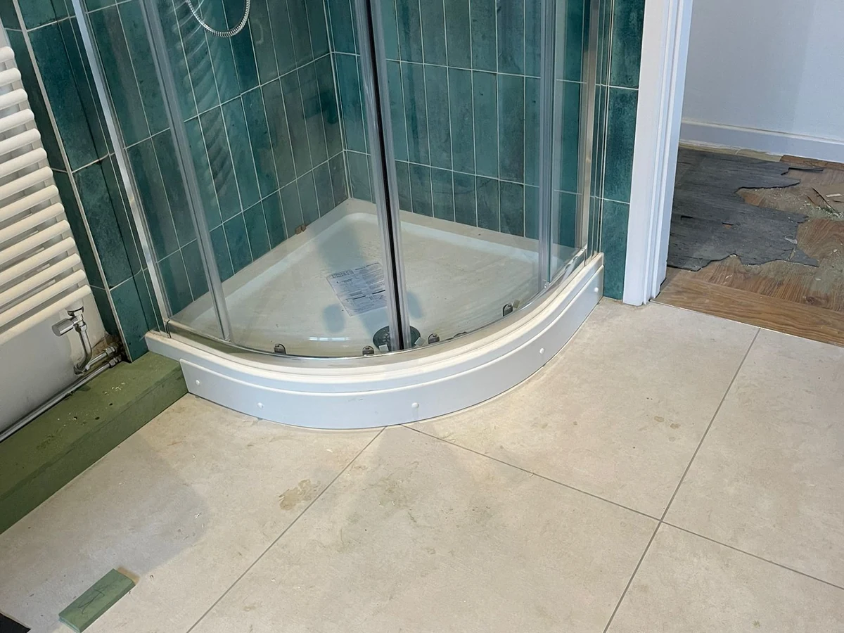 Bathroom fitting with quadrant shower tray and green tiles in Swansea by Daffodil Carpentry, professional bathroom fitters