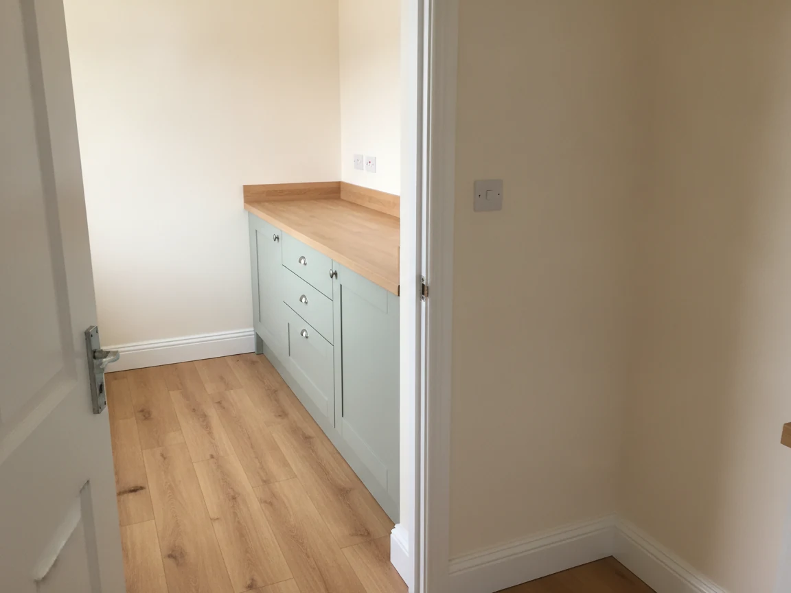 AI-generated illustration of painted kitchen walls, white skirting and wood-effect flooring