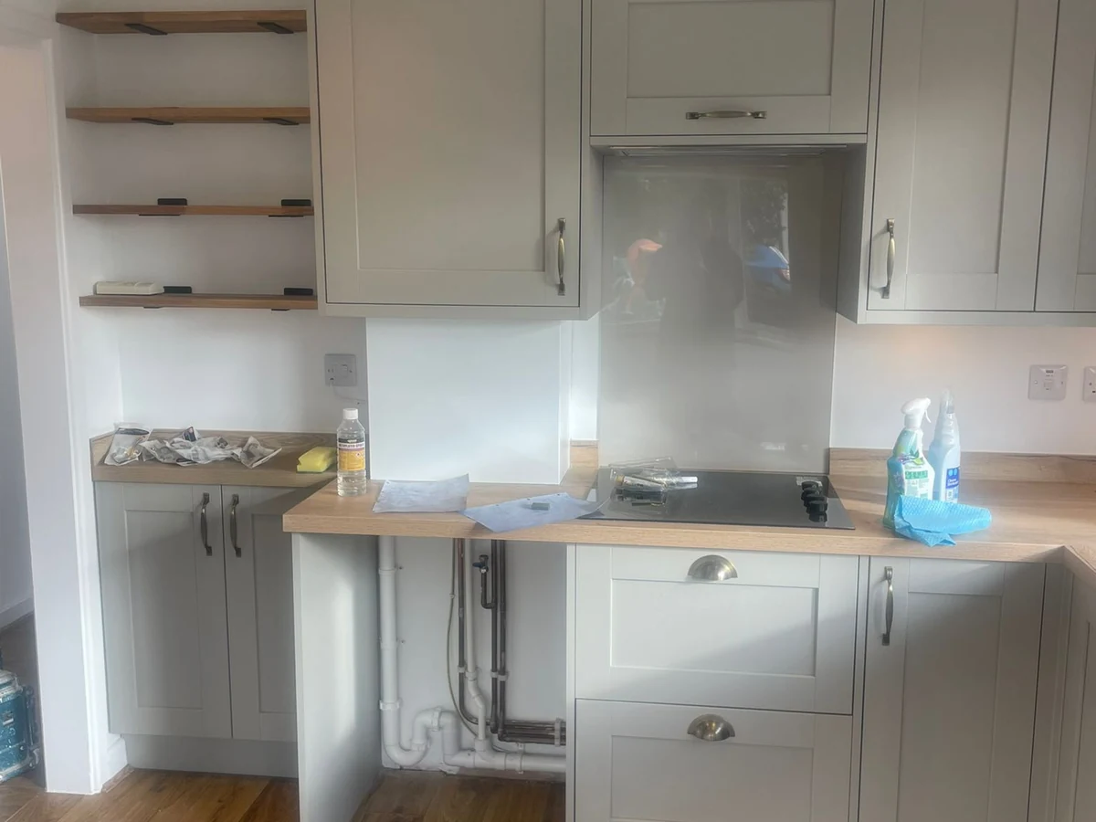 Cockett home with fresh kitchen cabinets in light sage green. Installed by Daffodil Carpentry, local kitchen fitters.